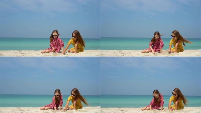两个快乐的小女孩在热带海滩玩得很开心
