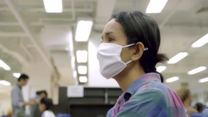 戴着口罩保护的年轻亚洲女性在公共场所感到恶心和咳嗽。