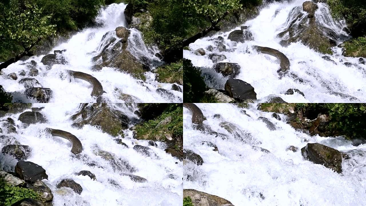 在绿色森林中，用跟踪布线在慢动作中特写石头和暴风雨山河的喷雾。全球变暖的概念和地球上淡水量的问题