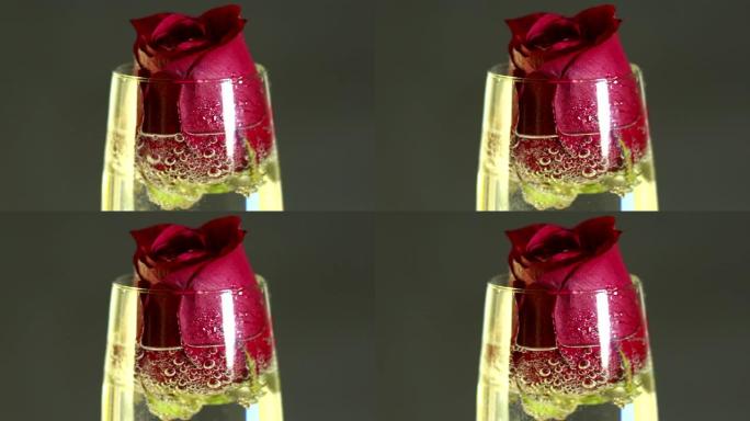 酒杯中的红玫瑰和香槟
