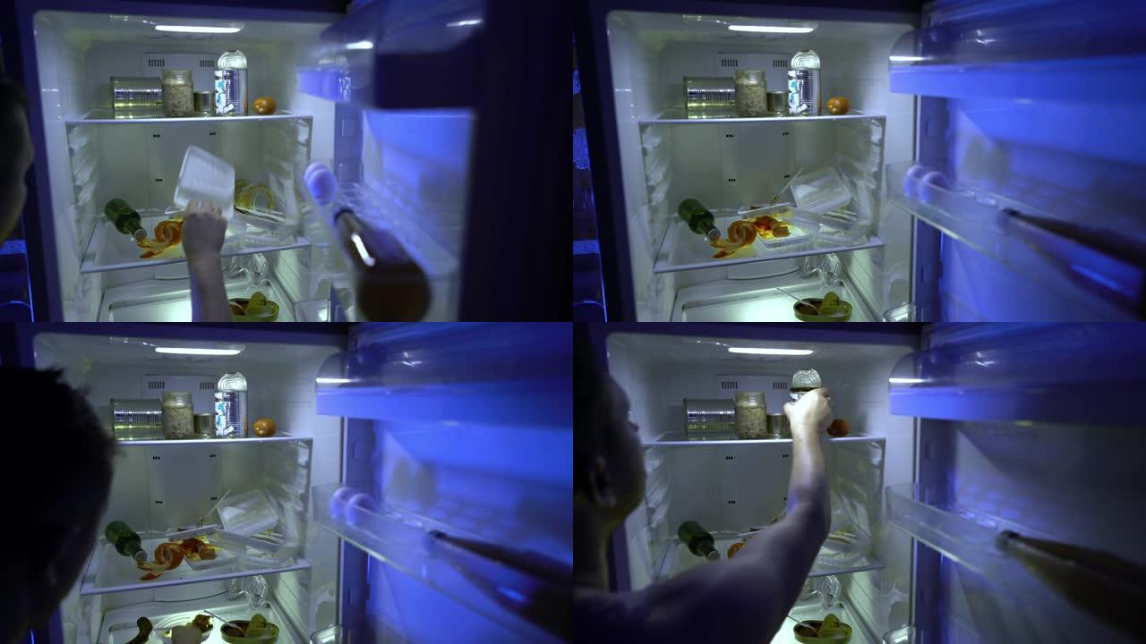 在冰箱里找食物的人。这个人打开冰箱，把鸡蛋放进里面。夜饿。