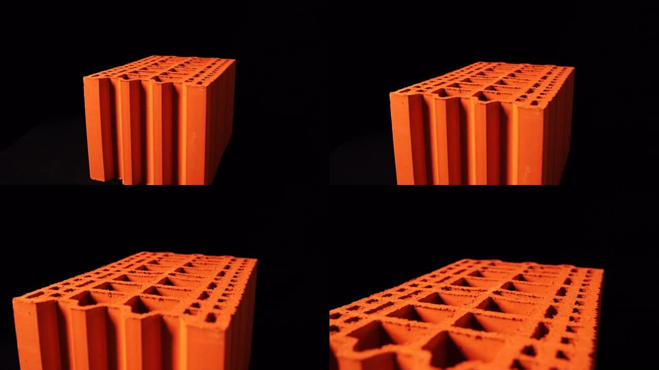 黑色背景上的3d橙色砖表面的抽象动画。库存镜头。建筑和材料概念