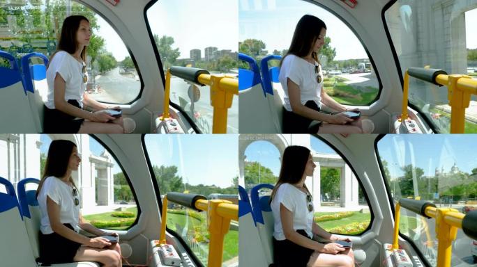 特写镜头，年轻迷人的女人在游览巴士上在马德里的地标上四处张望。西班牙。4K