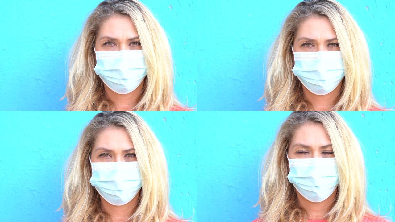 4k视频女人戴着防护面罩站在蓝色背景前