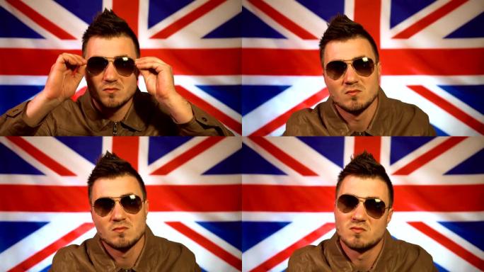 一个朋克的肖像穿着皮夹克和一个莫霍克在英国国旗的背景。英国球迷，人渣。