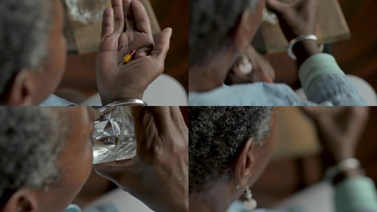 老年黑人妇女在家中服用药物胶囊药物