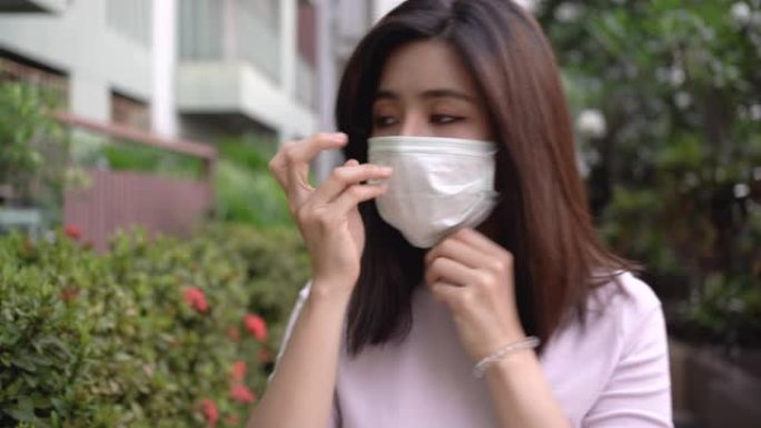 4k年轻的亚洲女士服装，粉红色上衣，在空闲时间出门前戴上口罩，健康和医疗理念，病毒疾病预防，空气污染