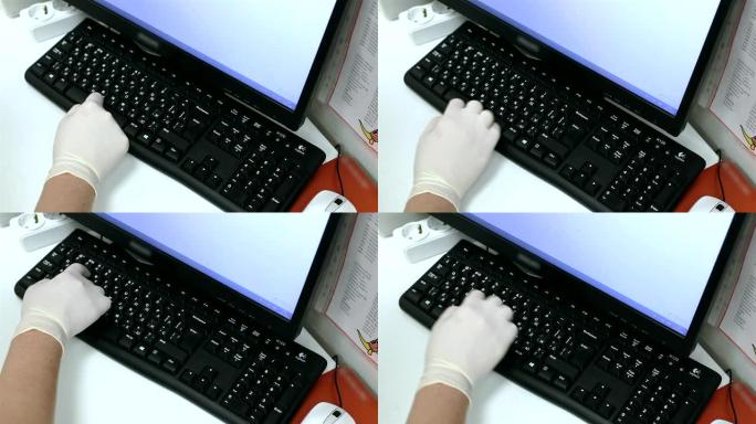 护士的手在电脑键盘上打字。