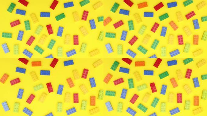 彩色砖块玩具在黄色背景上移动-停止运动