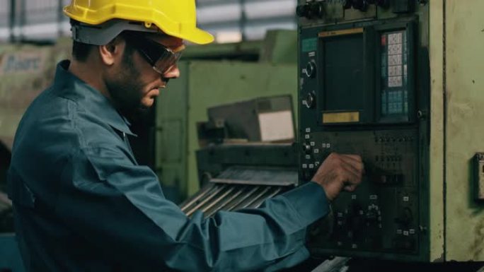 自信的中东人在工厂生产线上操作复杂的机器。制造概念。
