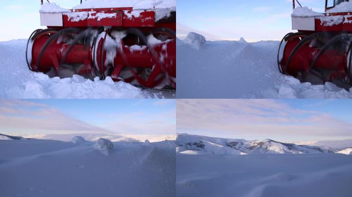 机器清理道路上的雪，吹雪机把雪扔得很高，远离道路，除雪机械