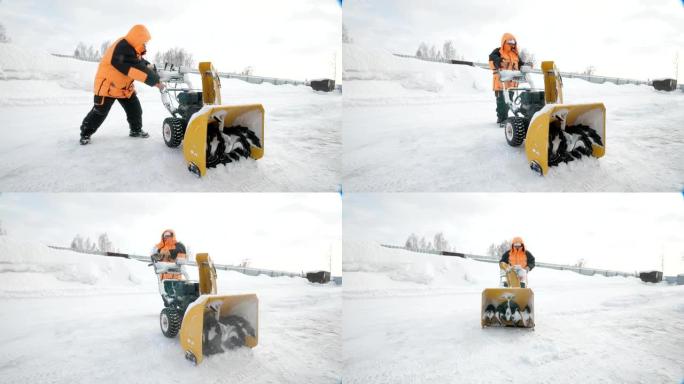 男人在冬天穿着橙色外套的扔雪器