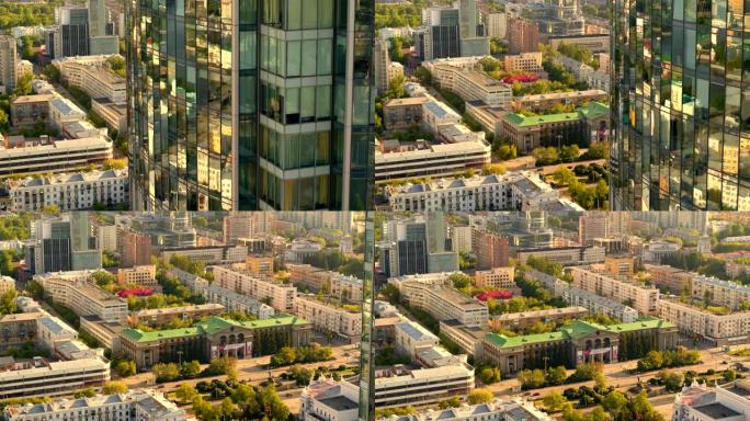 在温暖的晴天，夏天可以鸟瞰俄罗斯大城市，建筑物，树木和现代玻璃摩天大楼。库存镜头。美丽的城市景观