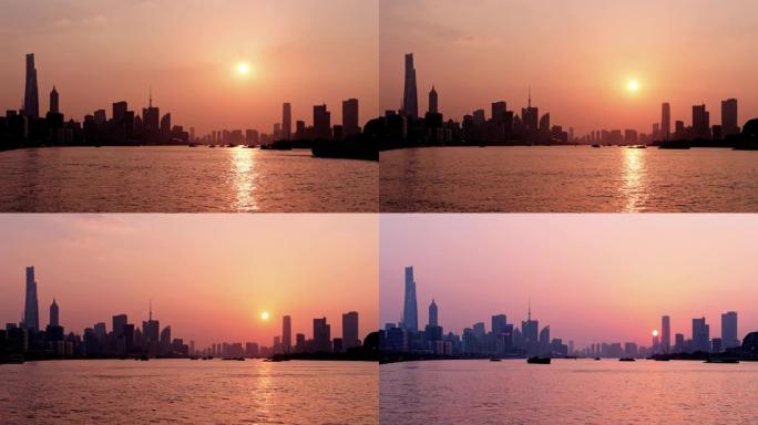 上海日落的延时镜头，外滩天际线和黄浦江背景，货船在河上航行，太阳向下移动到地平线，4k视频。
