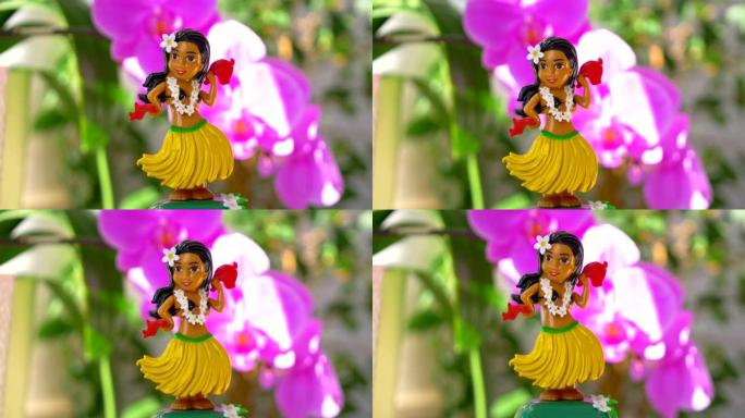 草裙舞女孩娃娃在4k慢动作60fps的花朵背景上跳舞