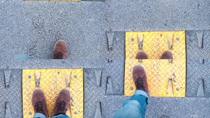一个穿着冬靴的男人在路上行走的腿的特写镜头。