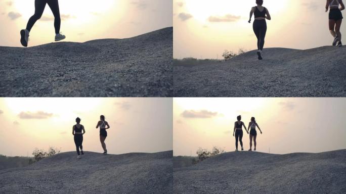 慢动作，越野跑伙伴朋友目标成功在岩山攀爬，运动员适合两名女性运动跑步者专业户外困难和挑战健康生活方式