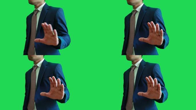 一个男人在绿色场景上展示手势。