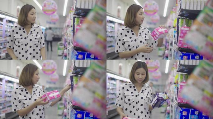 年轻的亚洲女性在超级市场购物