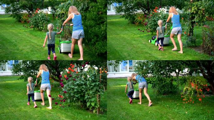 母亲在夏季花园里教小女儿女孩用割草机割草