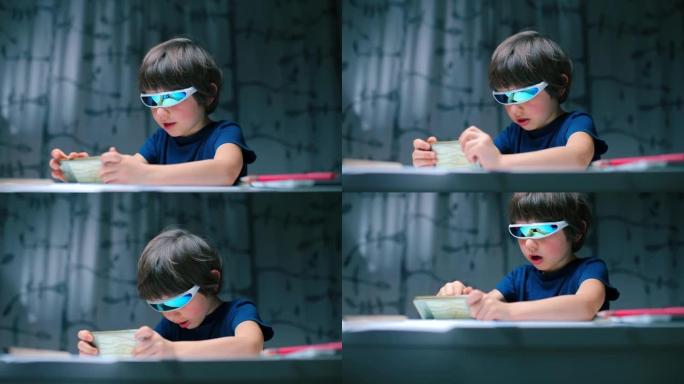 一个坐在桌子旁的虚拟眼镜男孩在智能手机上玩电子游戏。