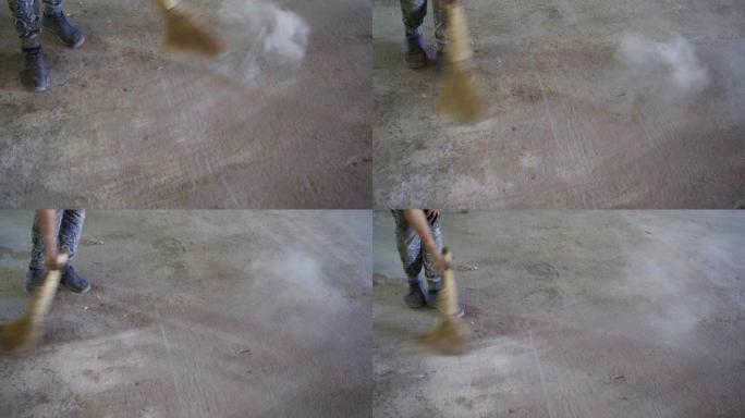 工人清扫尘土飞扬的混凝土地板