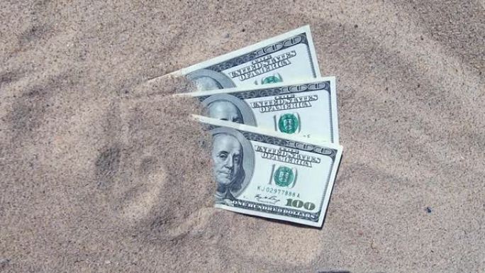 金钱多拉斯半被沙子覆盖在海滩上特写镜头