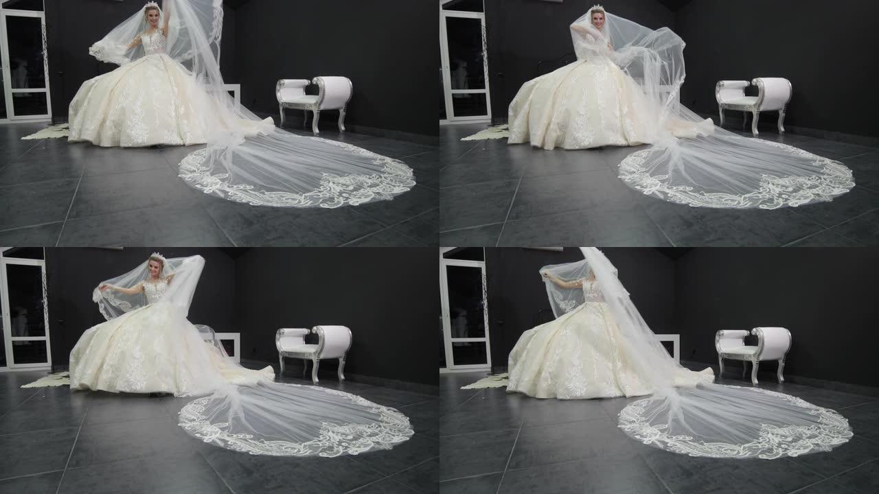 年轻漂亮的新娘穿着白色婚纱玩面纱把它推向