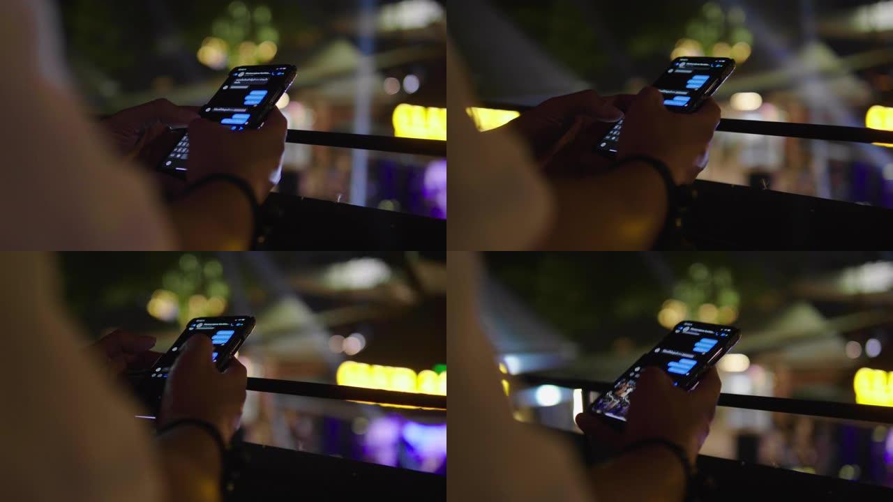 年轻人晚上在城市使用智能手机