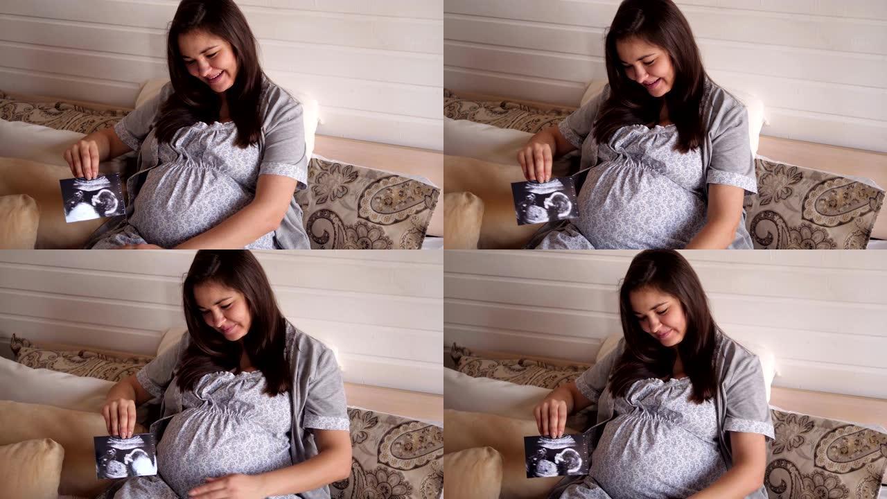 孕妇看婴儿超声波扫描的肖像。