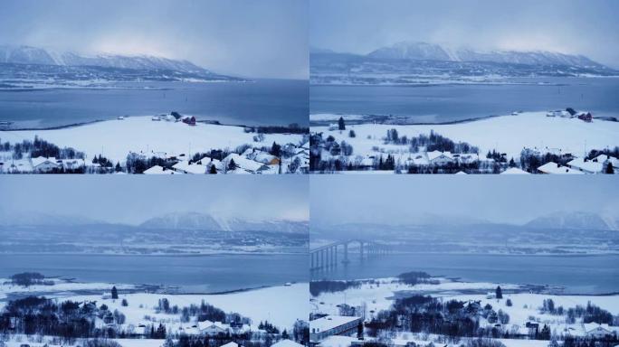 挪威北极降雪期间的特罗姆瑟冬季天际线