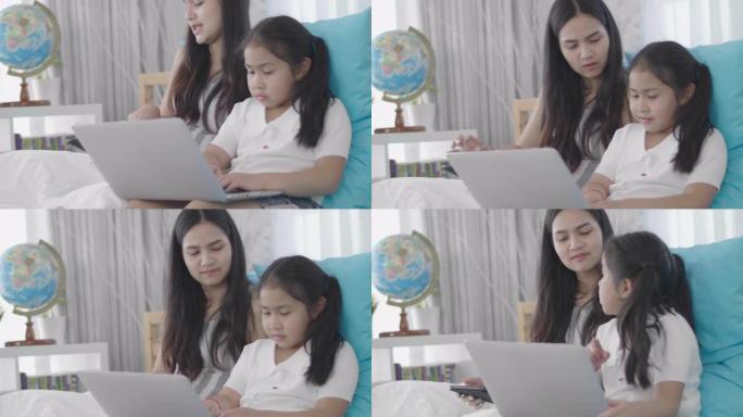 亚洲女孩和姐妹正在使用笔记本电脑，计算机和平板电脑连接到网络世界。小女孩在家休息时使用互联网。