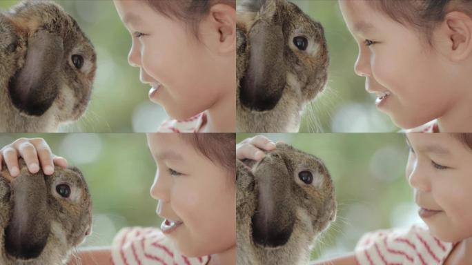亚洲小女孩看着小兔子的眼睛