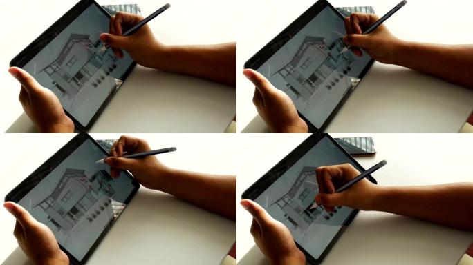 建筑师在数字平板电脑的平面图上绘制油漆