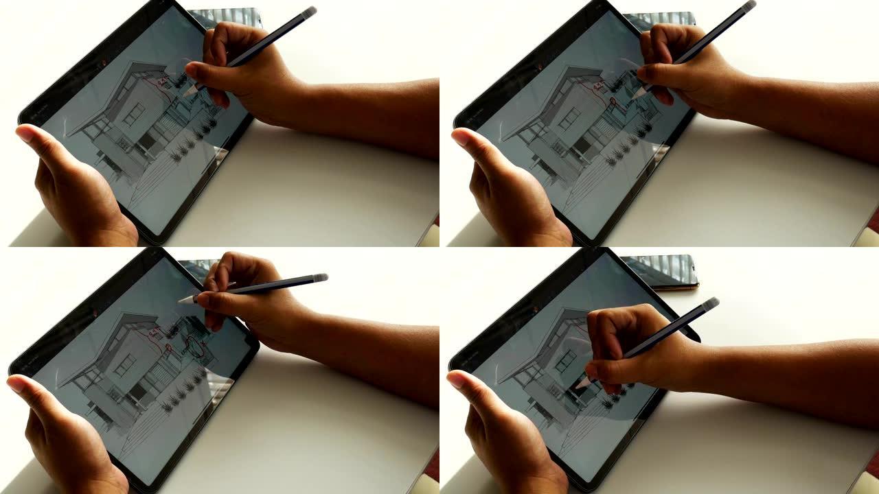 建筑师在数字平板电脑的平面图上绘制油漆