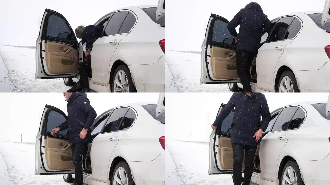 男子的腿和鞋退出汽车步入冬季积雪