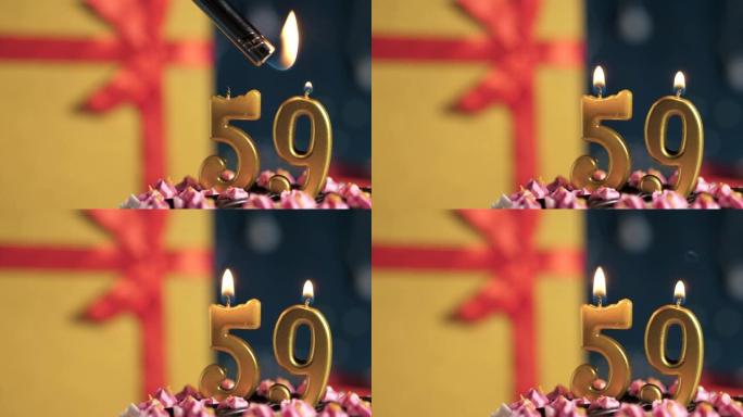 生日蛋糕编号59点灯燃烧的金色蜡烛，蓝色背景礼物黄色盒子用红丝带绑起来。特写和慢动作
