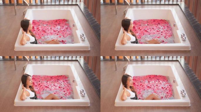 年轻的亚洲女性在浴缸里放松水疗