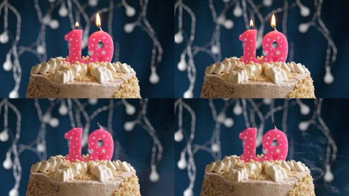 蓝色背景上有19号粉色蜡烛的生日蛋糕。蜡烛吹灭了。慢动作和特写视图