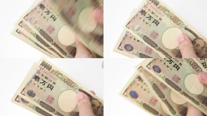 日本钞票数在白桌上。
