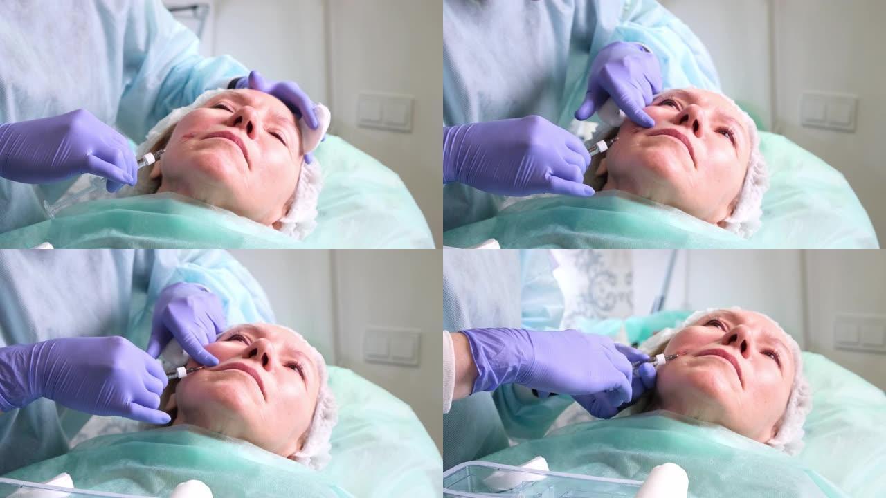 50岁的中年妇女正在由医生美容师向面部注射透明质酸。美容程序。特写