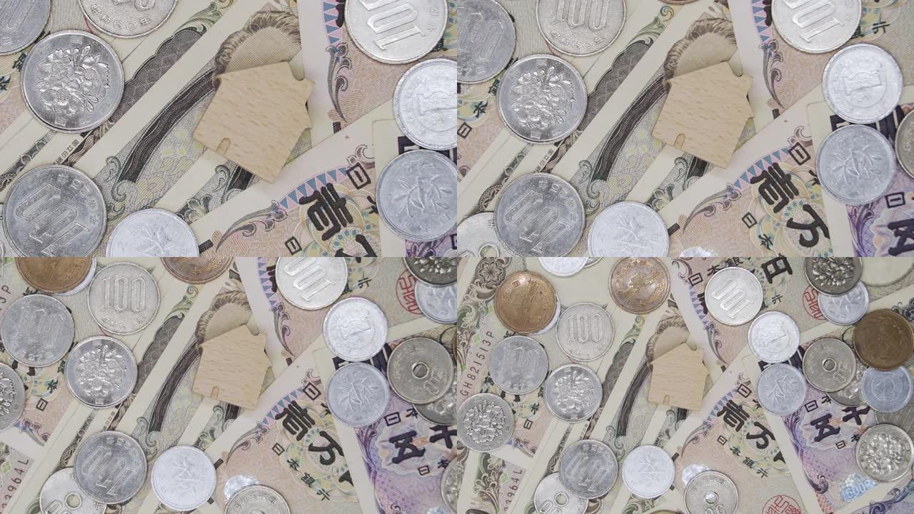 缩小拍摄顶视图木制家庭图标在日本货币日元钞票。