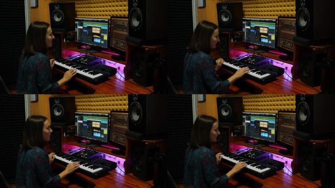 女人在专业录音棚里弹电钢琴和创作歌曲。女音乐家在sound music studio演奏钢琴midi