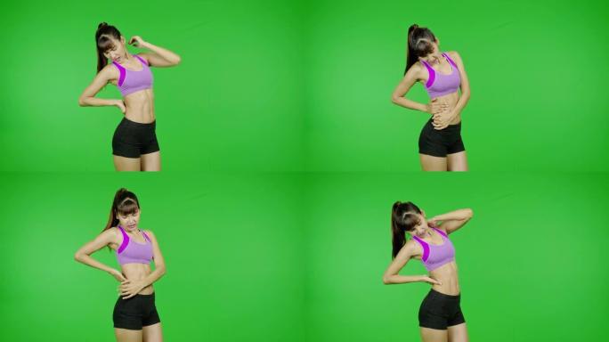 背部受伤，绿屏，锻炼，运动事故，受伤。适合年轻的亚洲体育女子在紫色的布在痛苦的锻炼在镜头前。