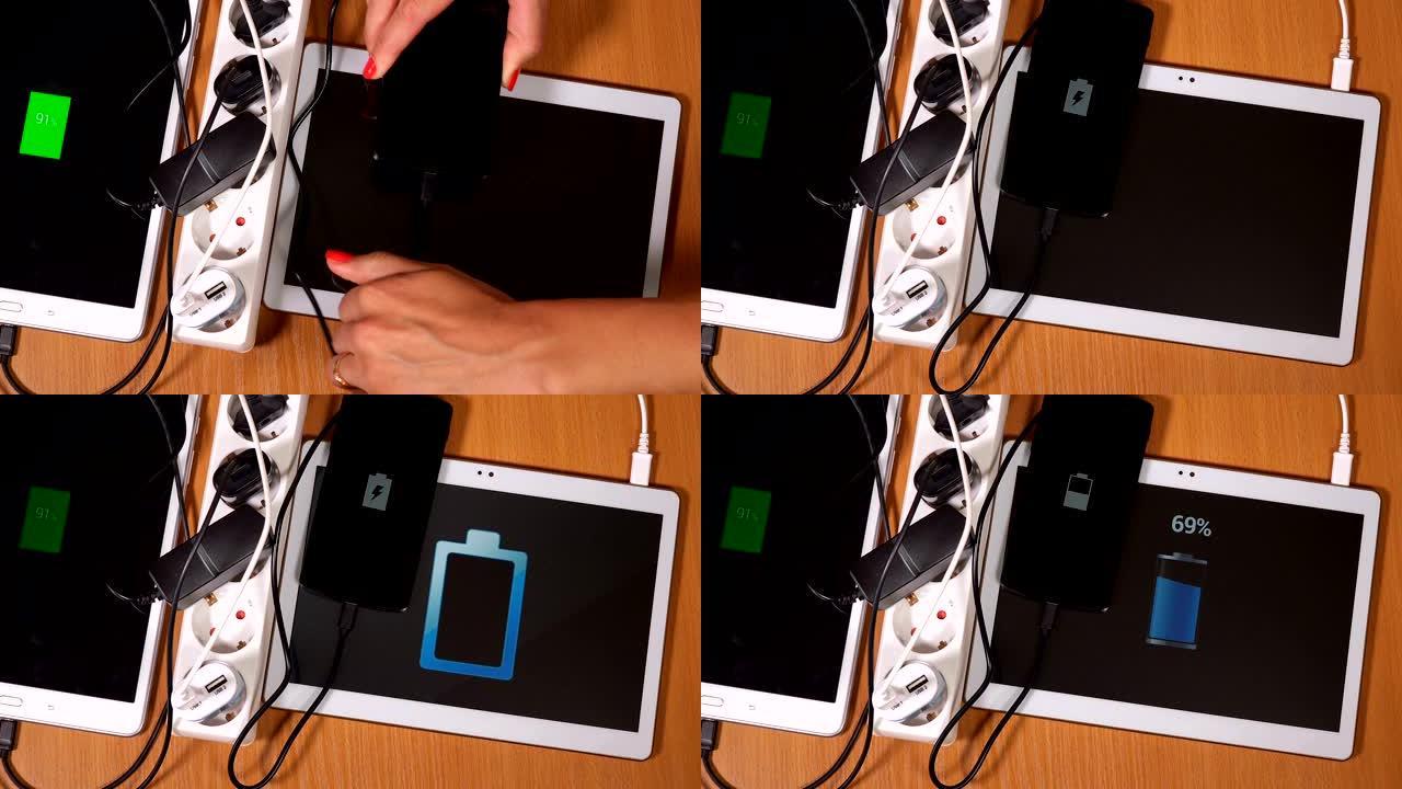 用手将平板电脑和电话插入扩展插座中的充电器