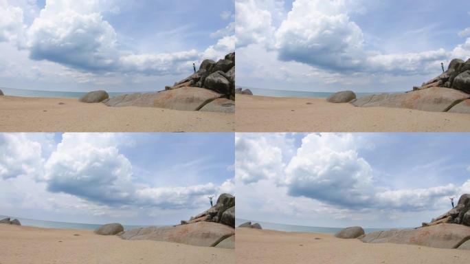 亚洲妇女在海滩上的岩石上呼吸新鲜空气