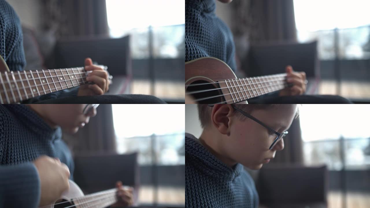 小男孩在家弹吉他玩耍娱乐