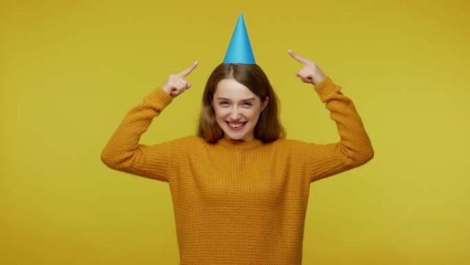 Excited joyful girl in pullover pointing at funny 