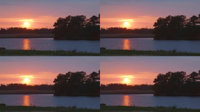 金色日落期间平静的湖，有倒影