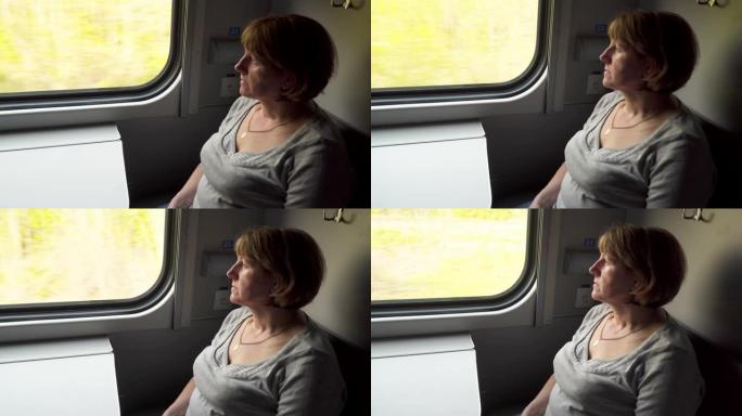 年轻女子坐在窗边的火车车厢里